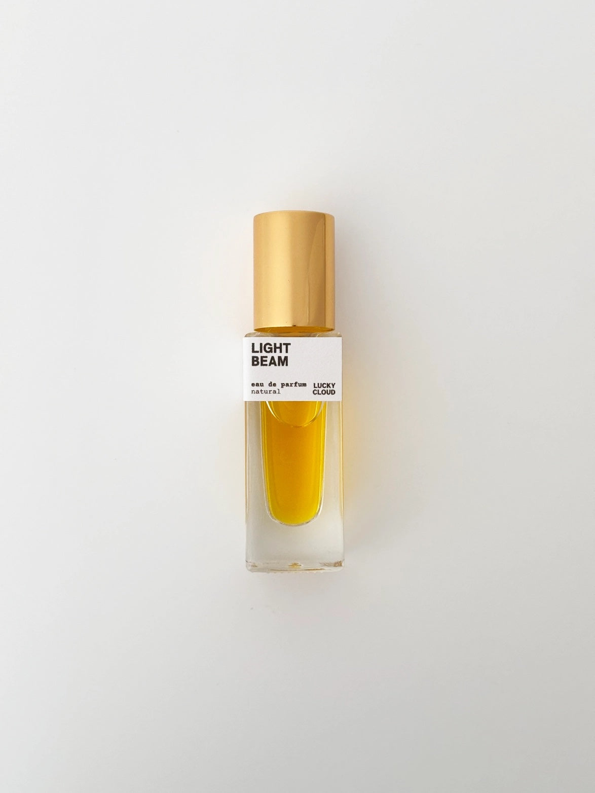 Perfume bottle labeled 'Light Beam' on a light gray background