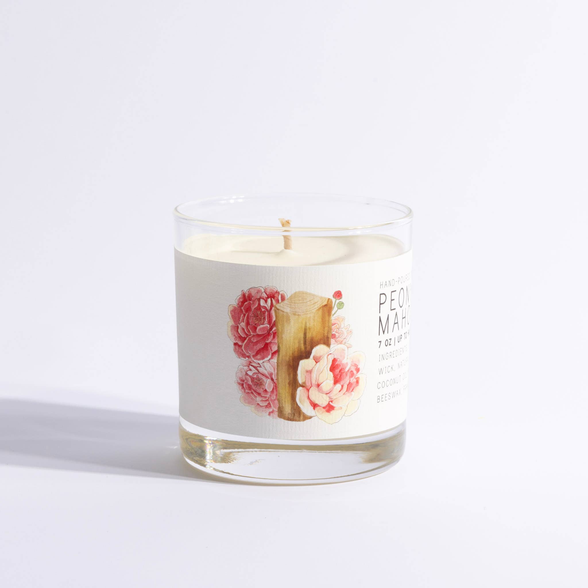 Candle in a glass jar with floral design on a white background