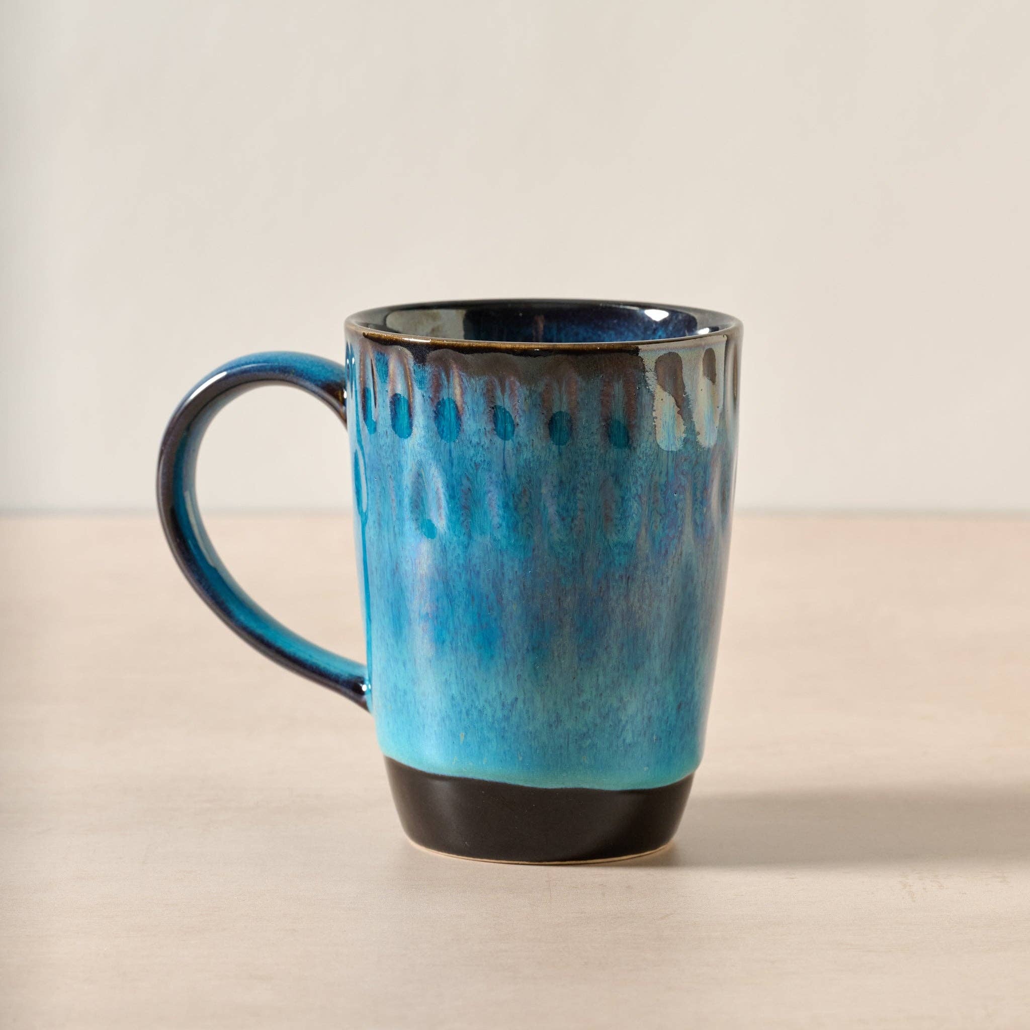 Blue ceramic mug on a beige surface