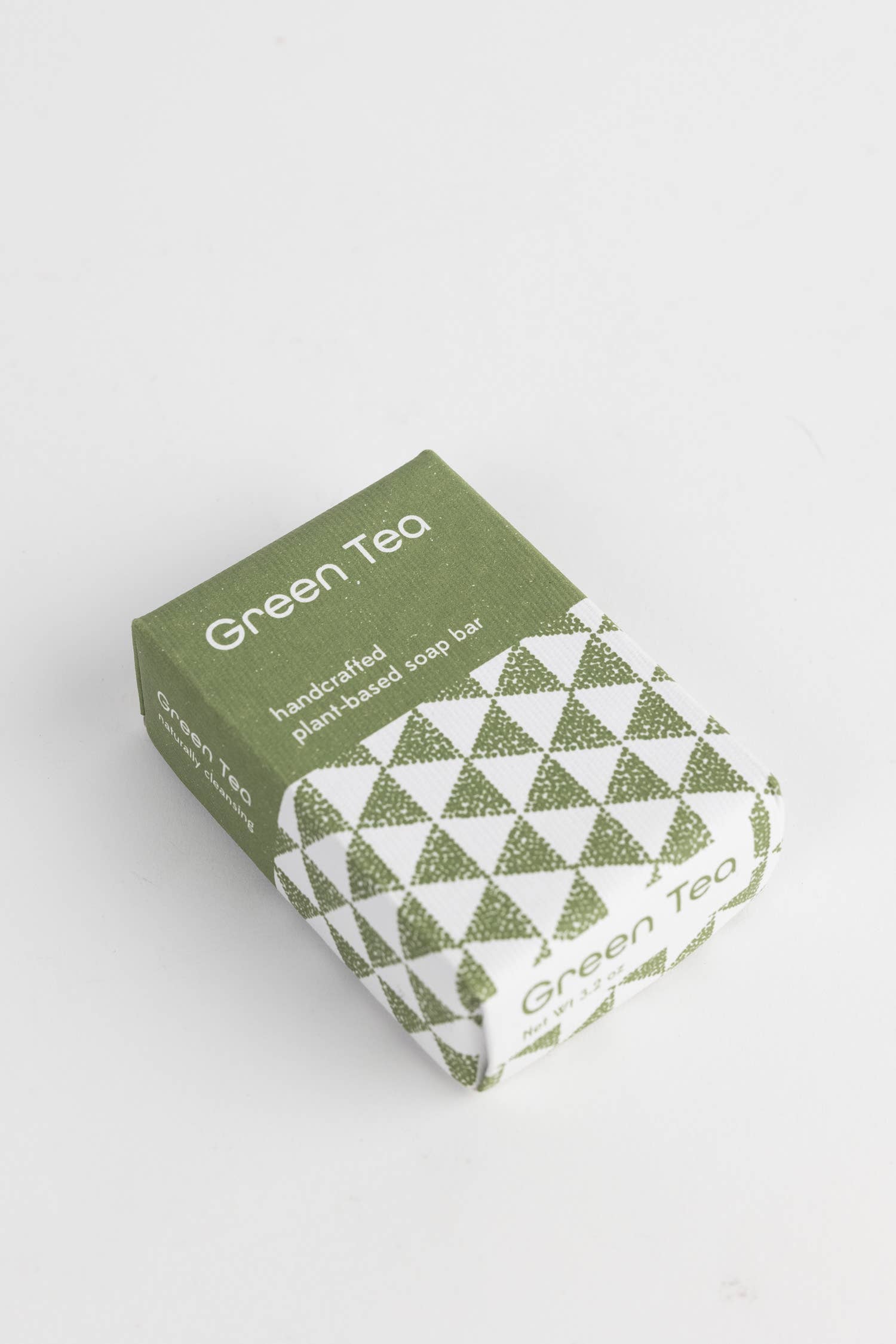 Green tea soap bar with packaging on a white background