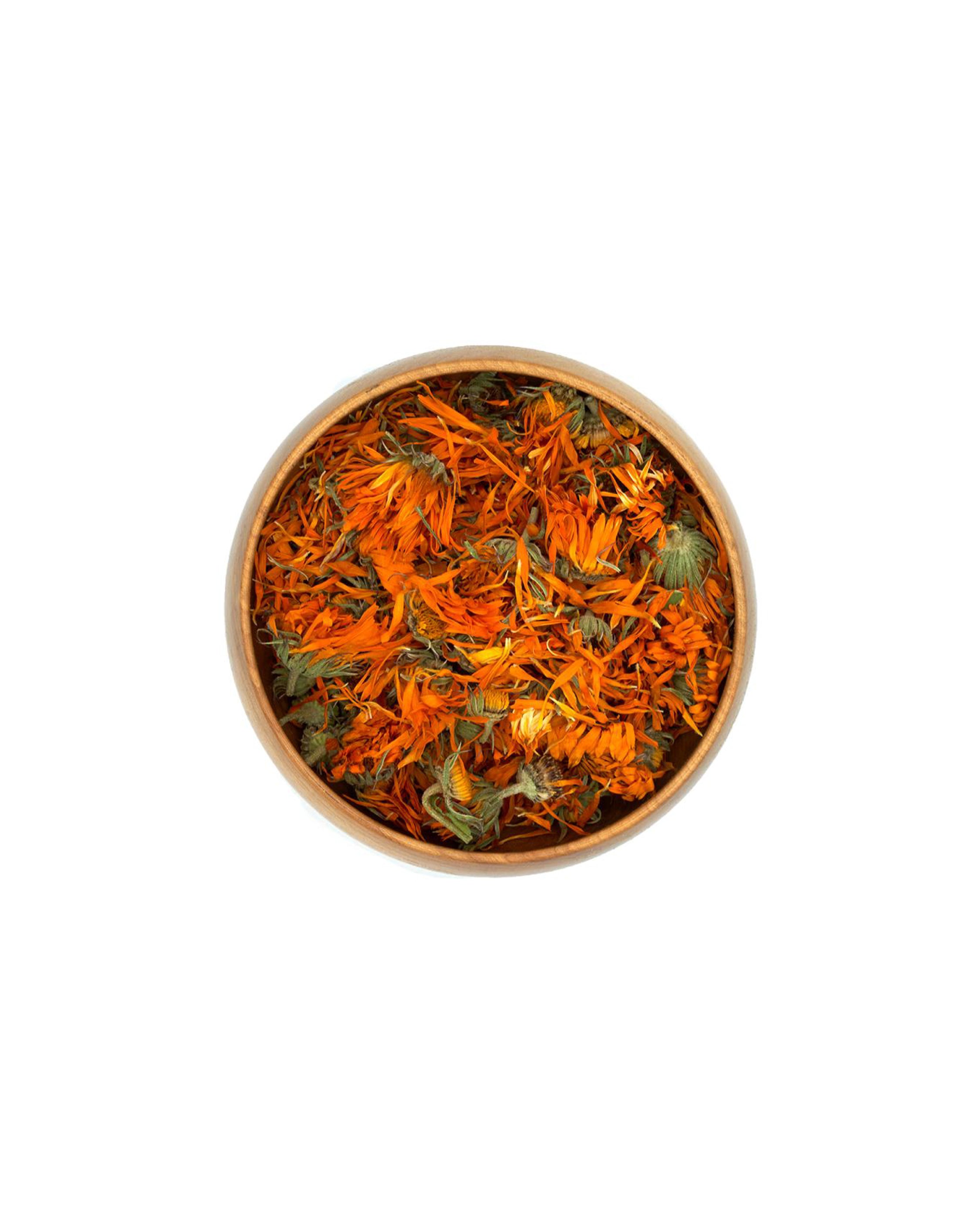 Bowl of dried marigold flowers on a white background