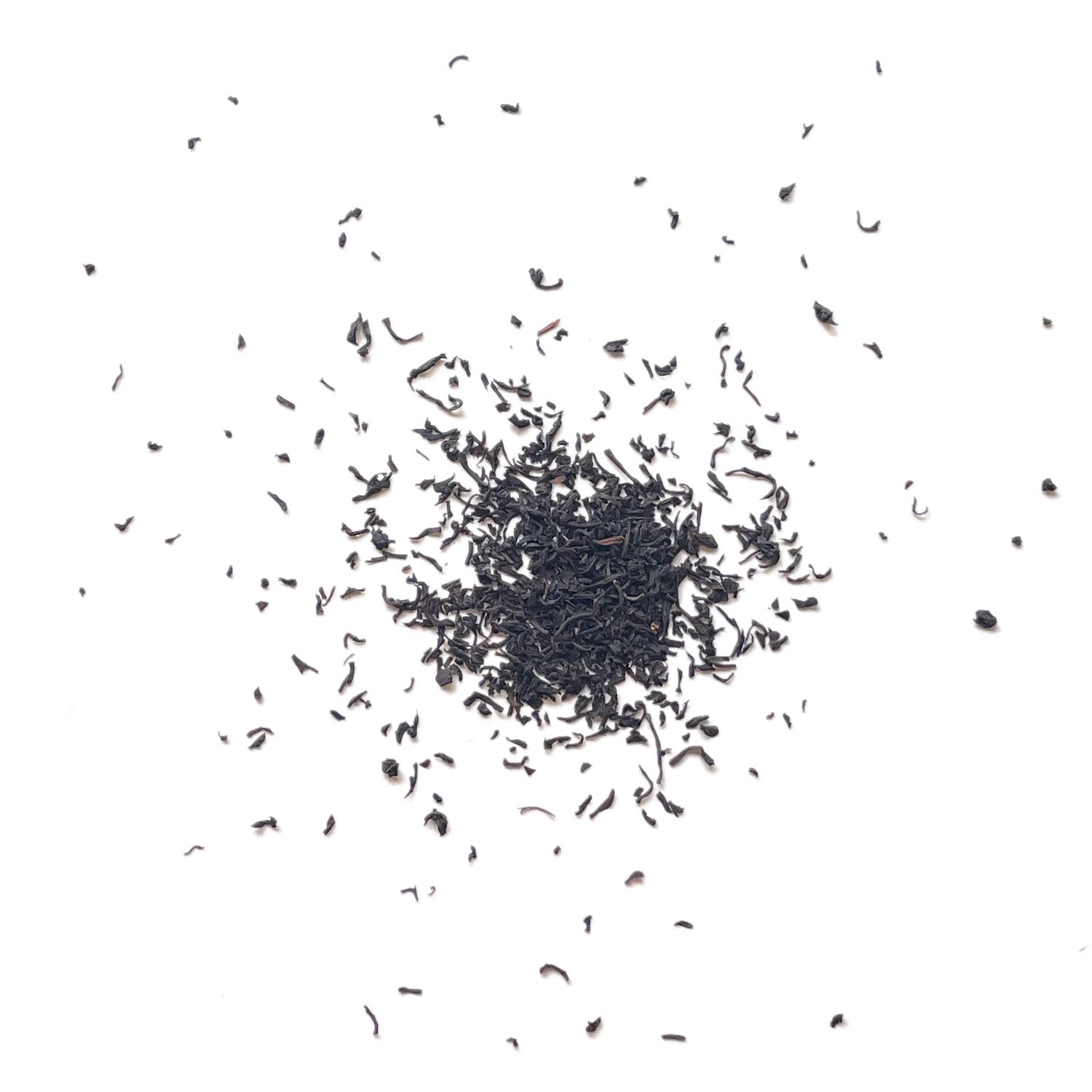 Tea leaves scattered on a white background