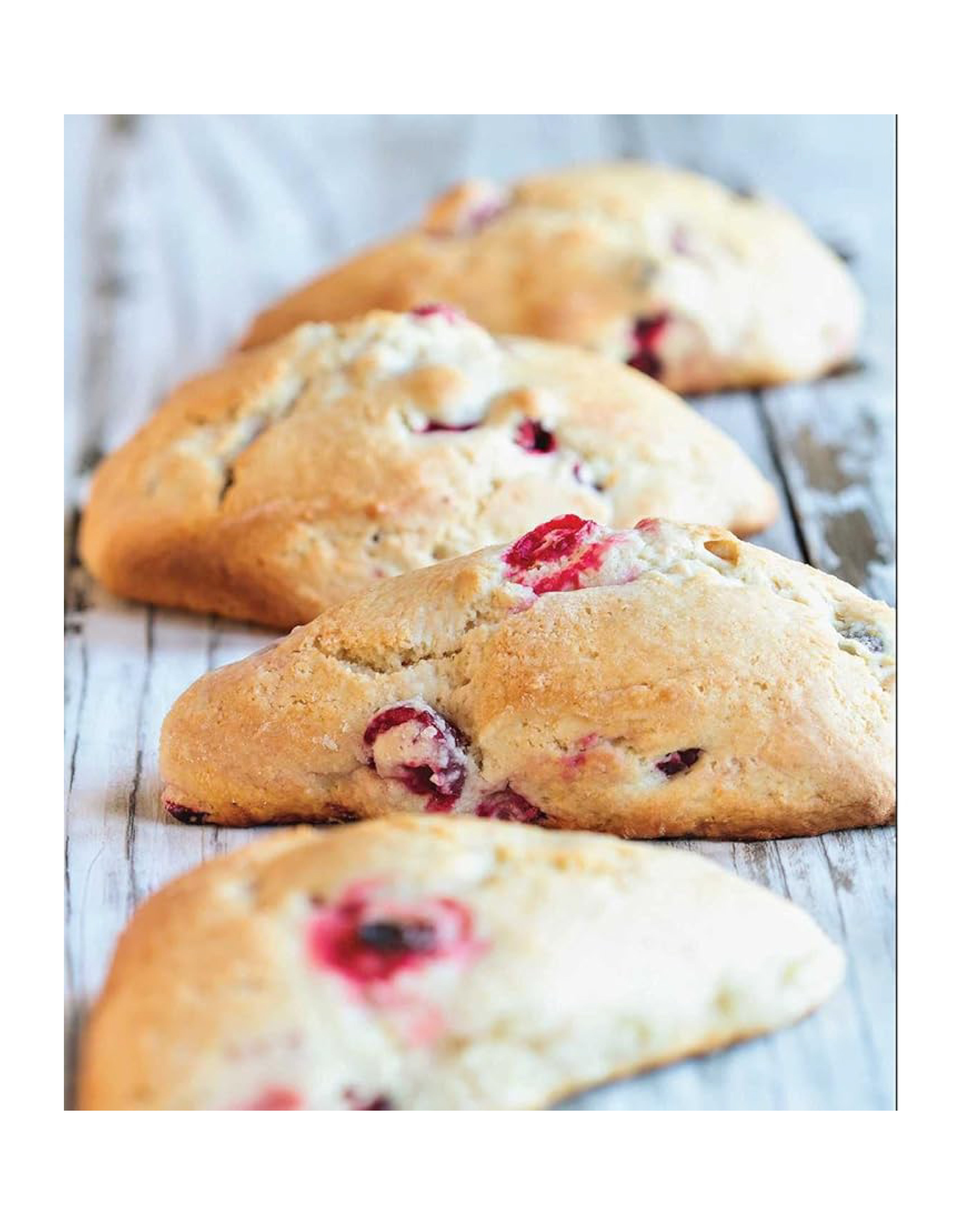 Baked goods with berries on a wooden surface