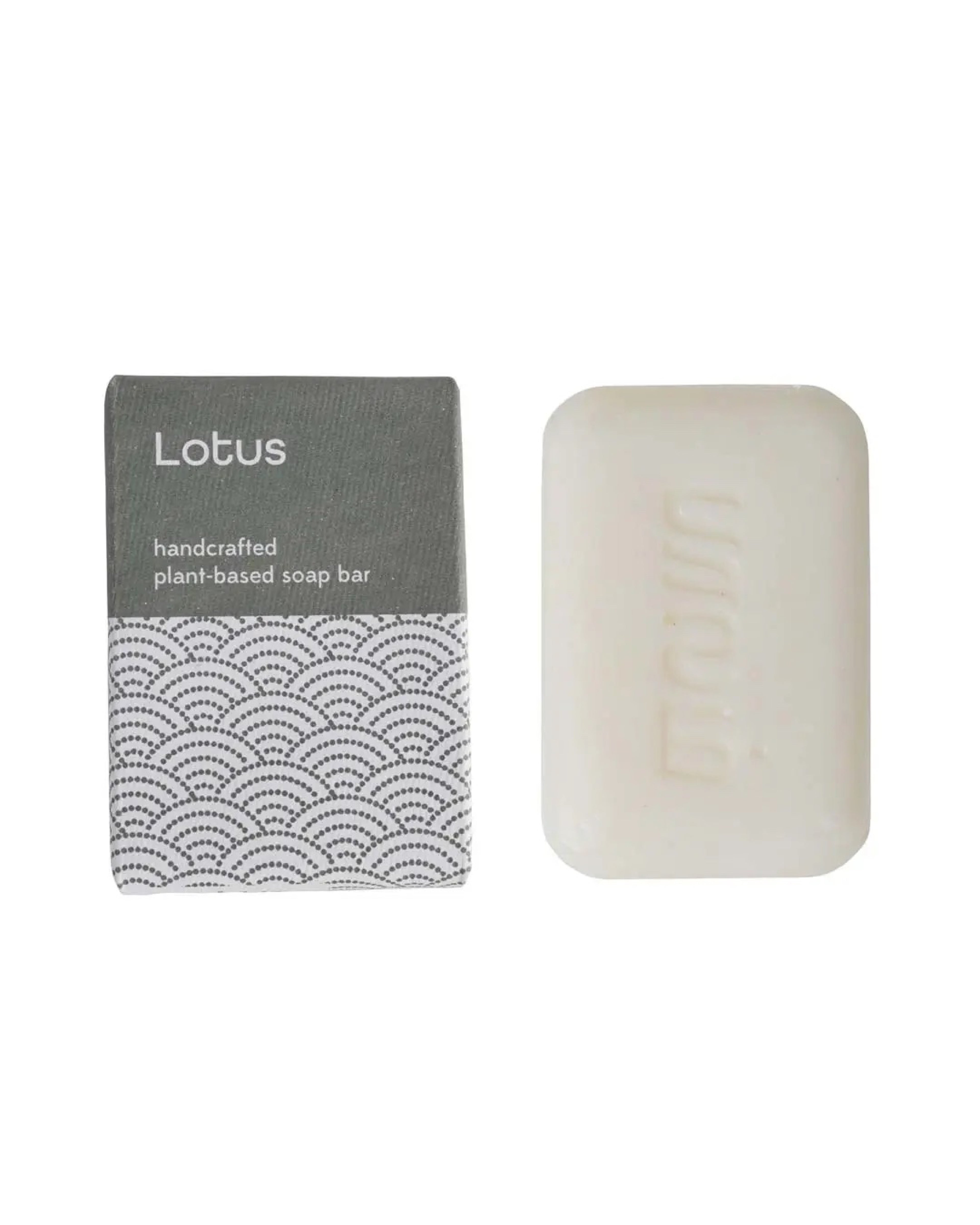 Handcrafted lotus soap bar with packaging on a white background