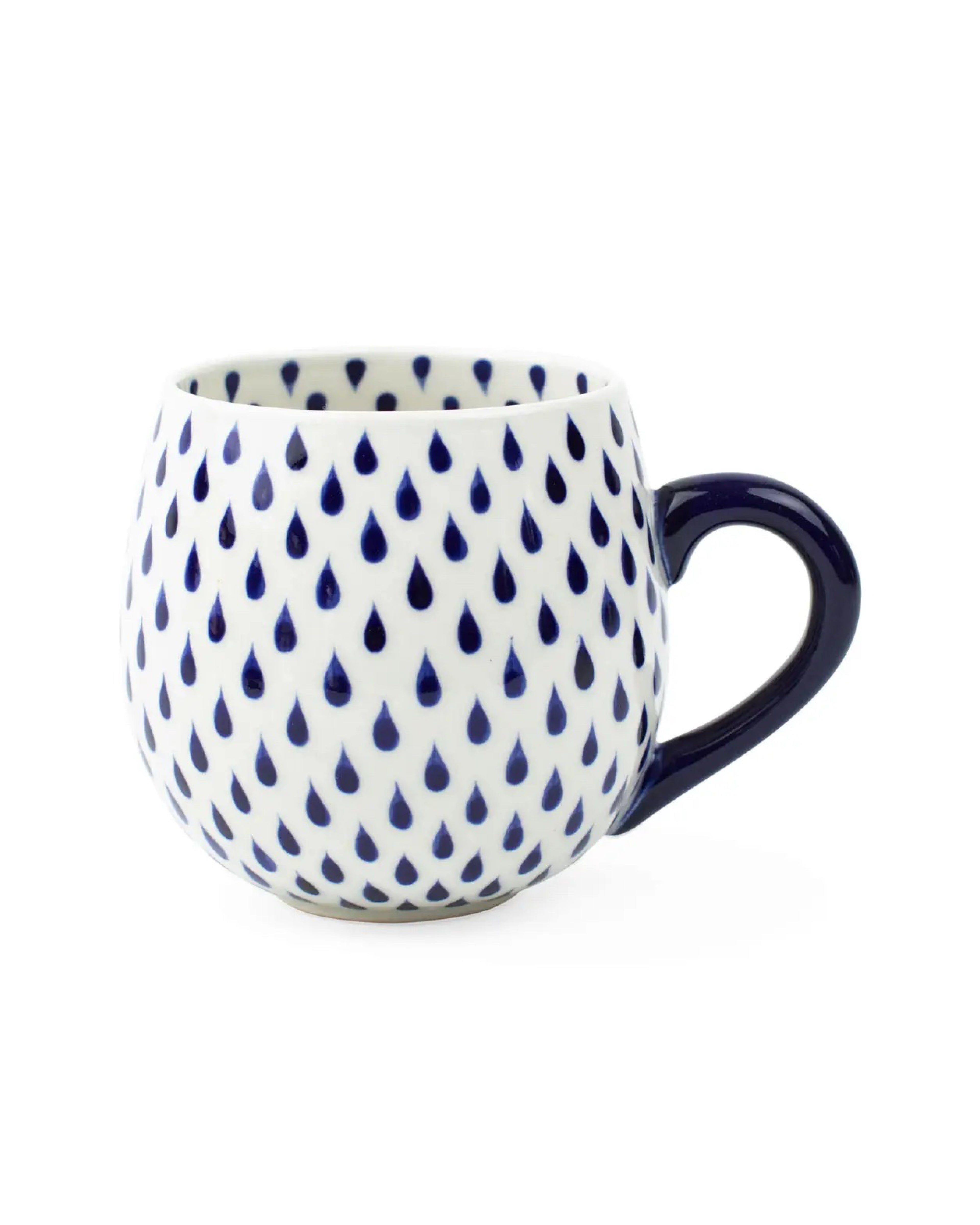 White mug with blue teardrop pattern on a white background