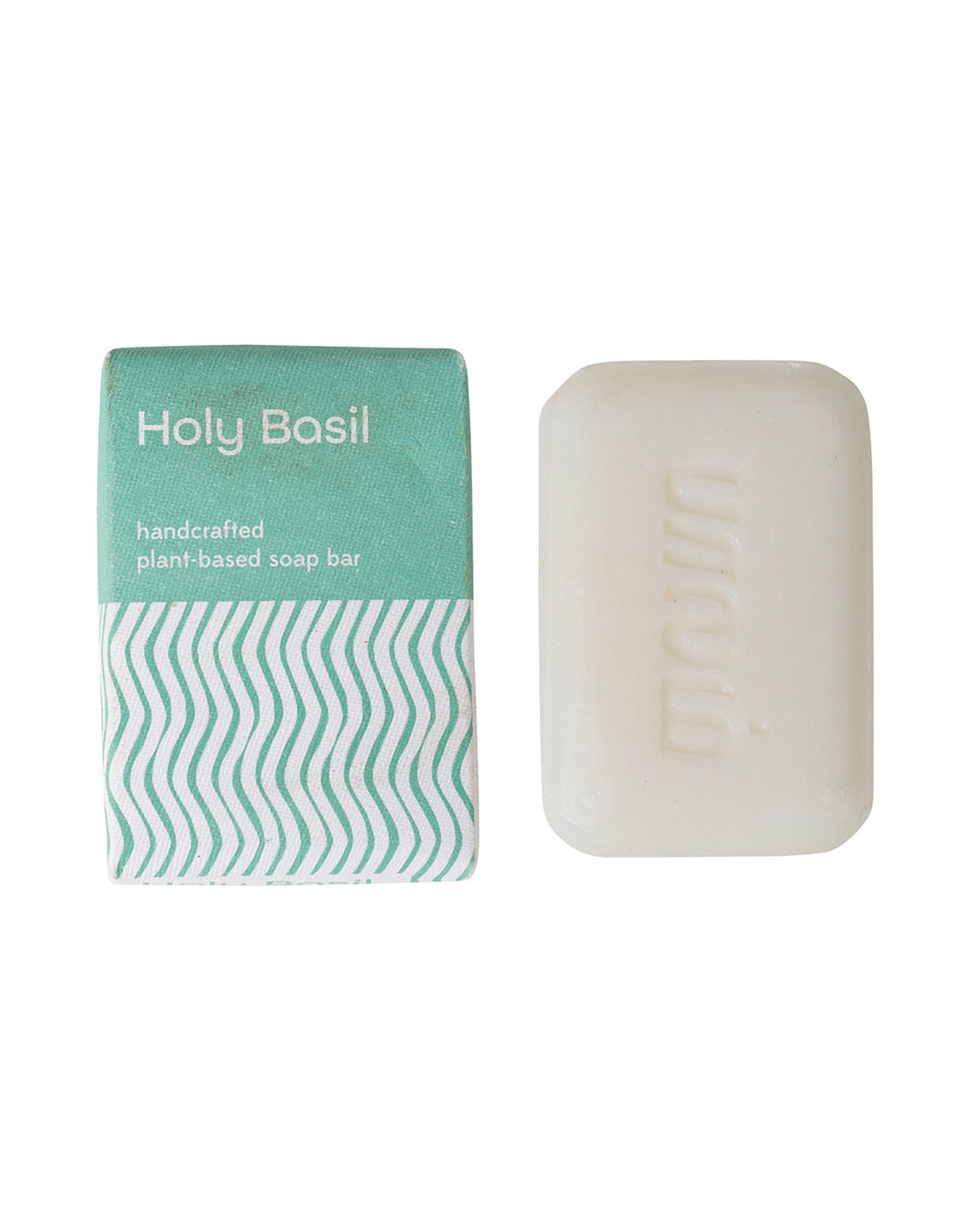 Handcrafted tulsi soap bar with packaging on a white background