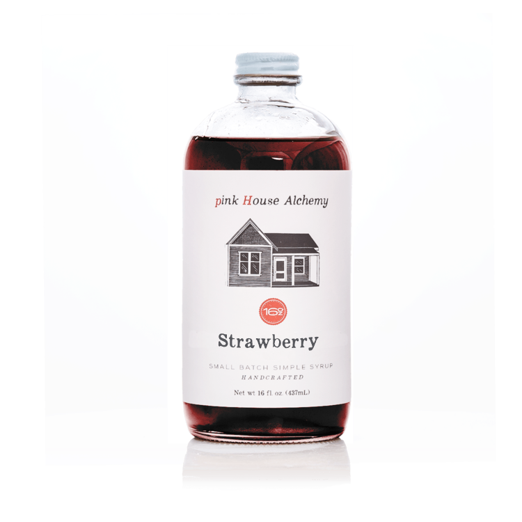 Bottle of strawberry syrup from pink House Alchemy on a white background
