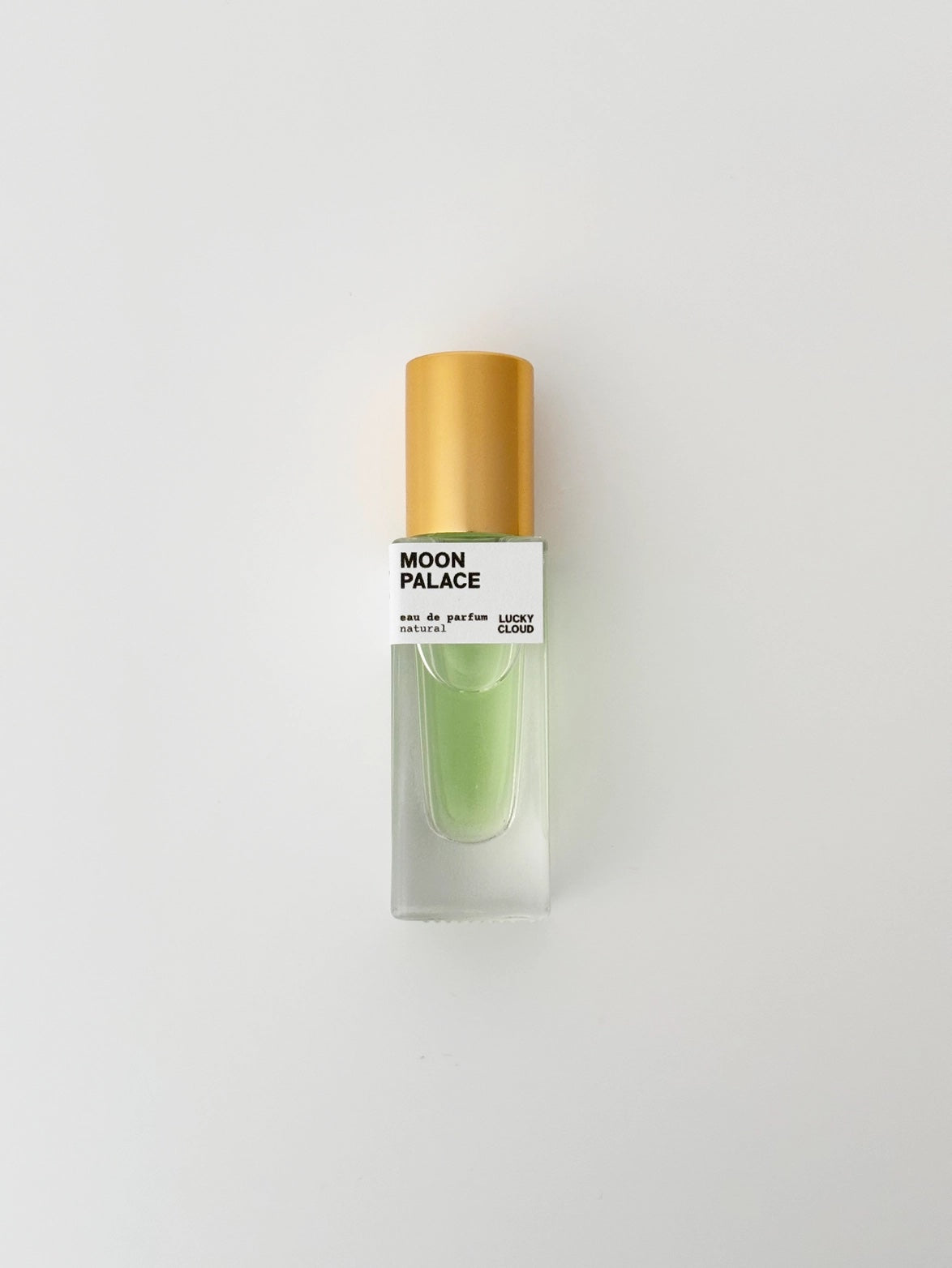 Perfume bottle labeled 'Moon Palace' on a light gray background