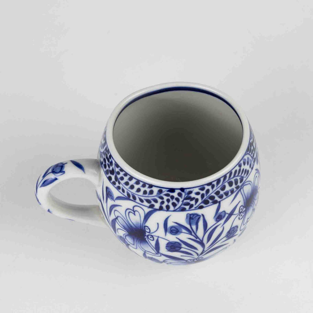 White mug with blue floral patterns on a white background