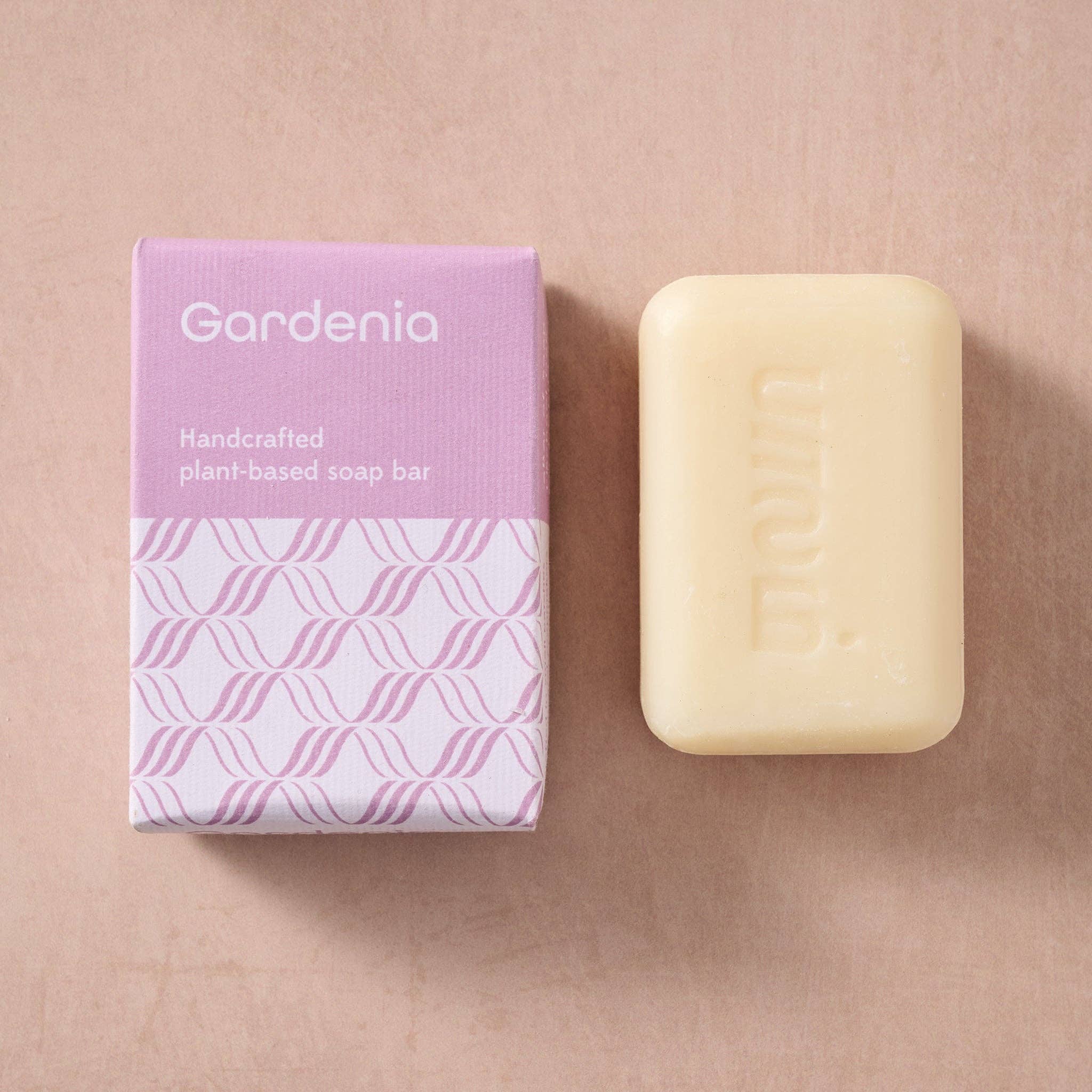 Gardenia plant-based soap bar with packaging on a beige background