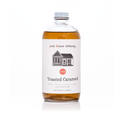 Bottle of Toasted Caramel syrup from pink House Alchemy on a white background