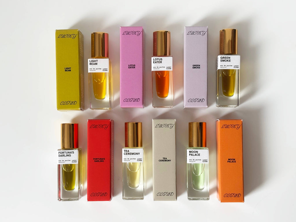 Collection of colorful perfume bottles and boxes on a white background