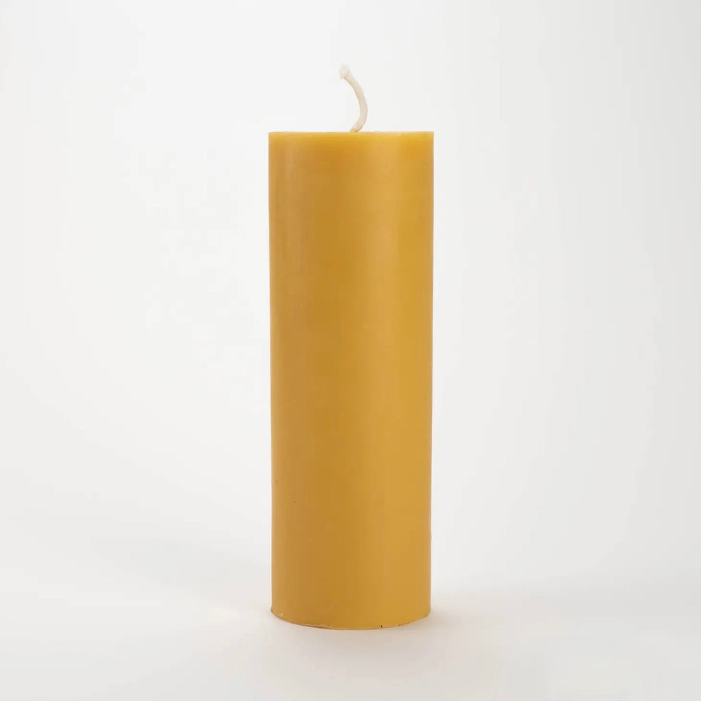 Yellow candle on a white background