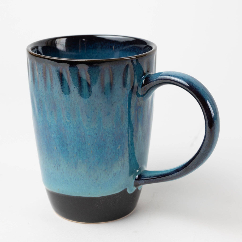 Blue ceramic mug with black accents on a white background