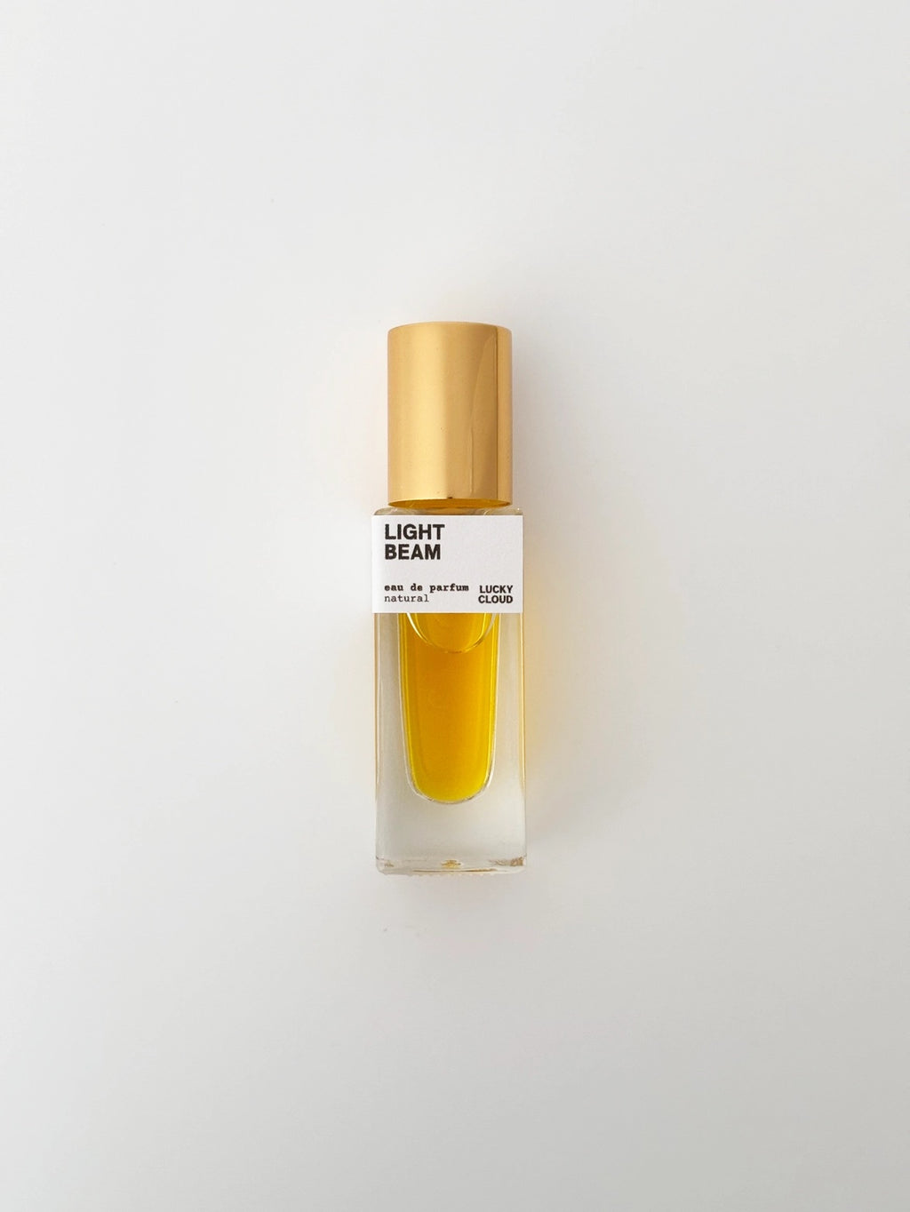 Perfume bottle labeled 'Light Beam' on a light gray background