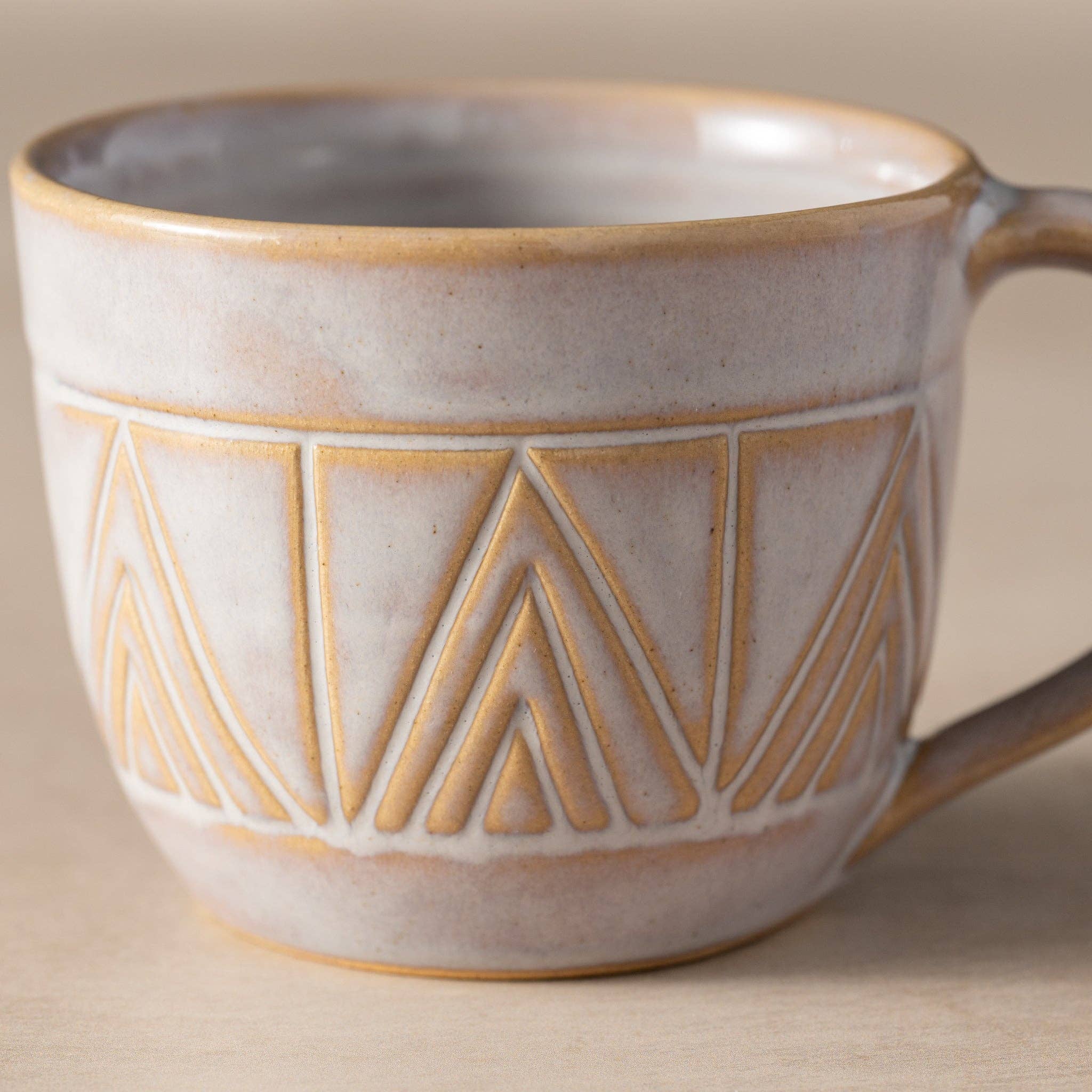 Ceramic mug with geometric pattern on a neutral background