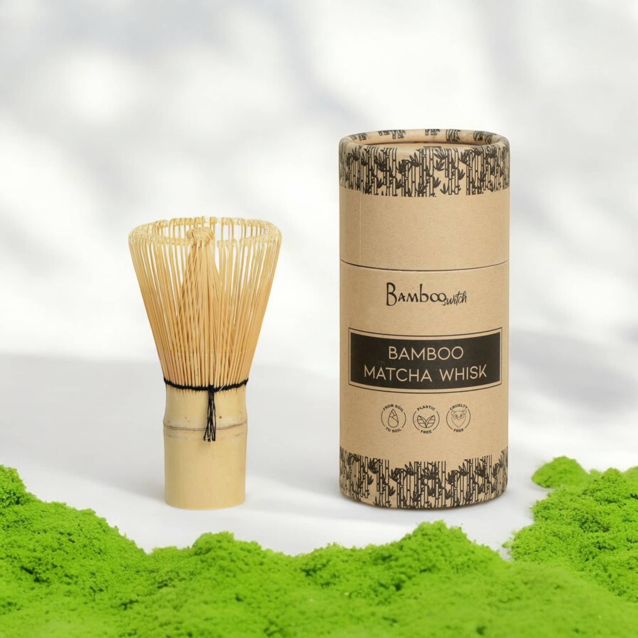 Bamboo matcha whisk with packaging on a white background with green powder.