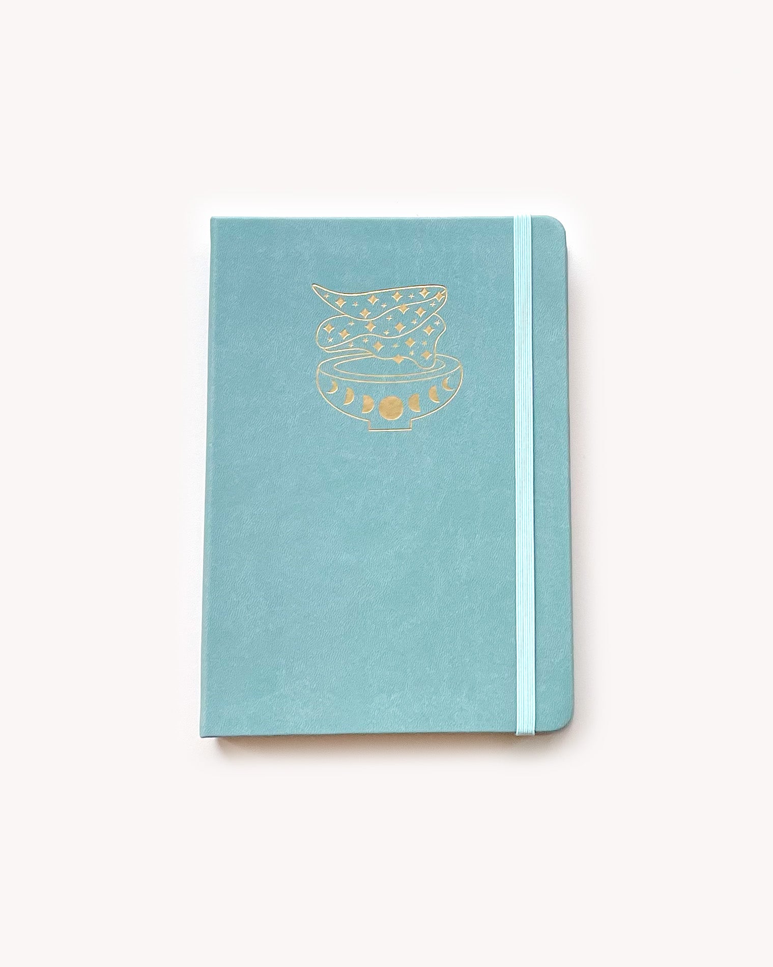 Light blue notebook with gold design on a white background