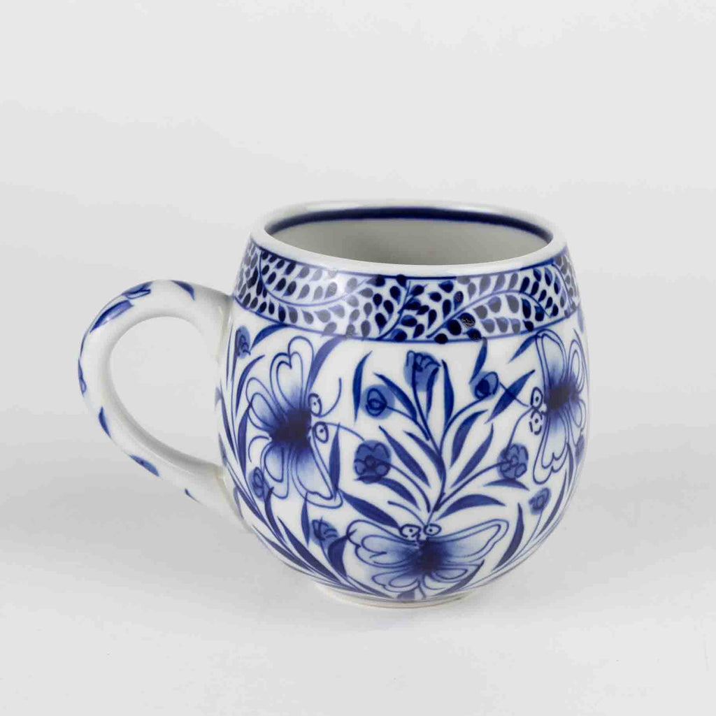 Ceramic mug with blue floral patterns on a white background