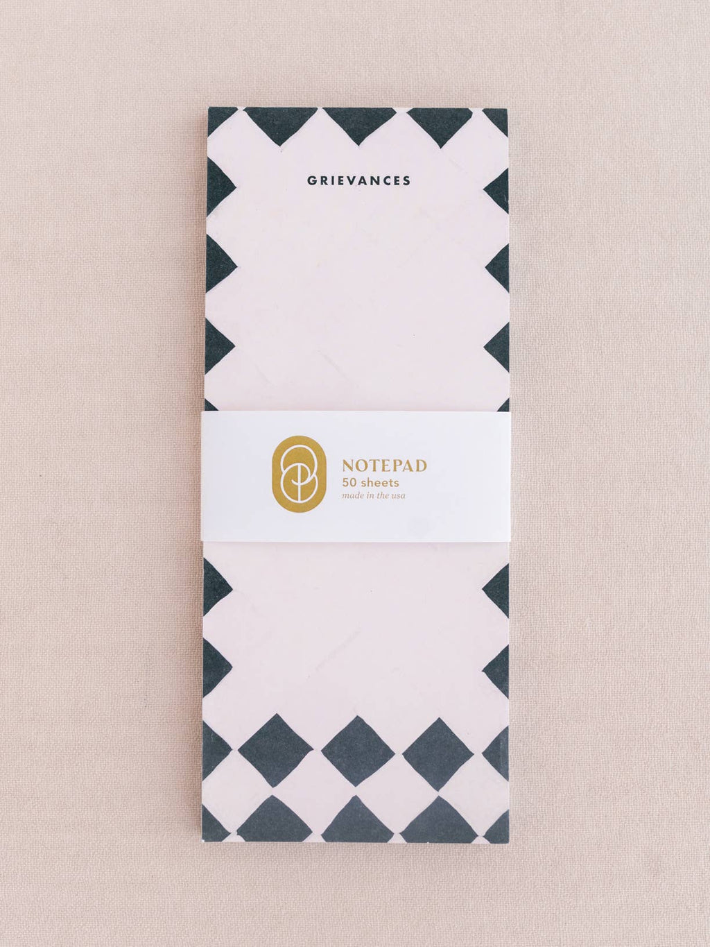 Notepad with geometric design on a beige background