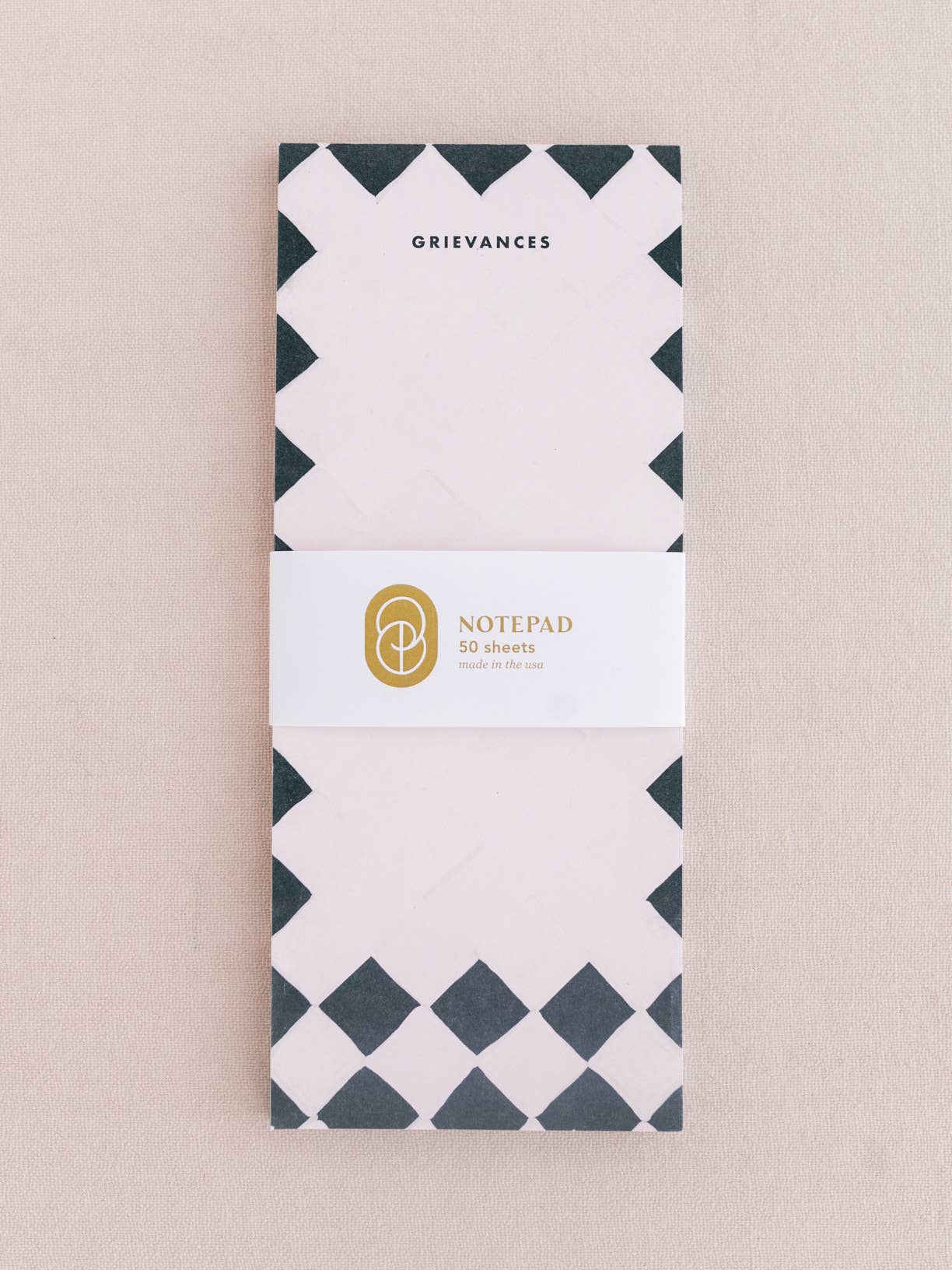 Notepad with geometric design on a beige background