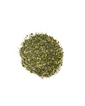 Pile of dried green herbs on a white background