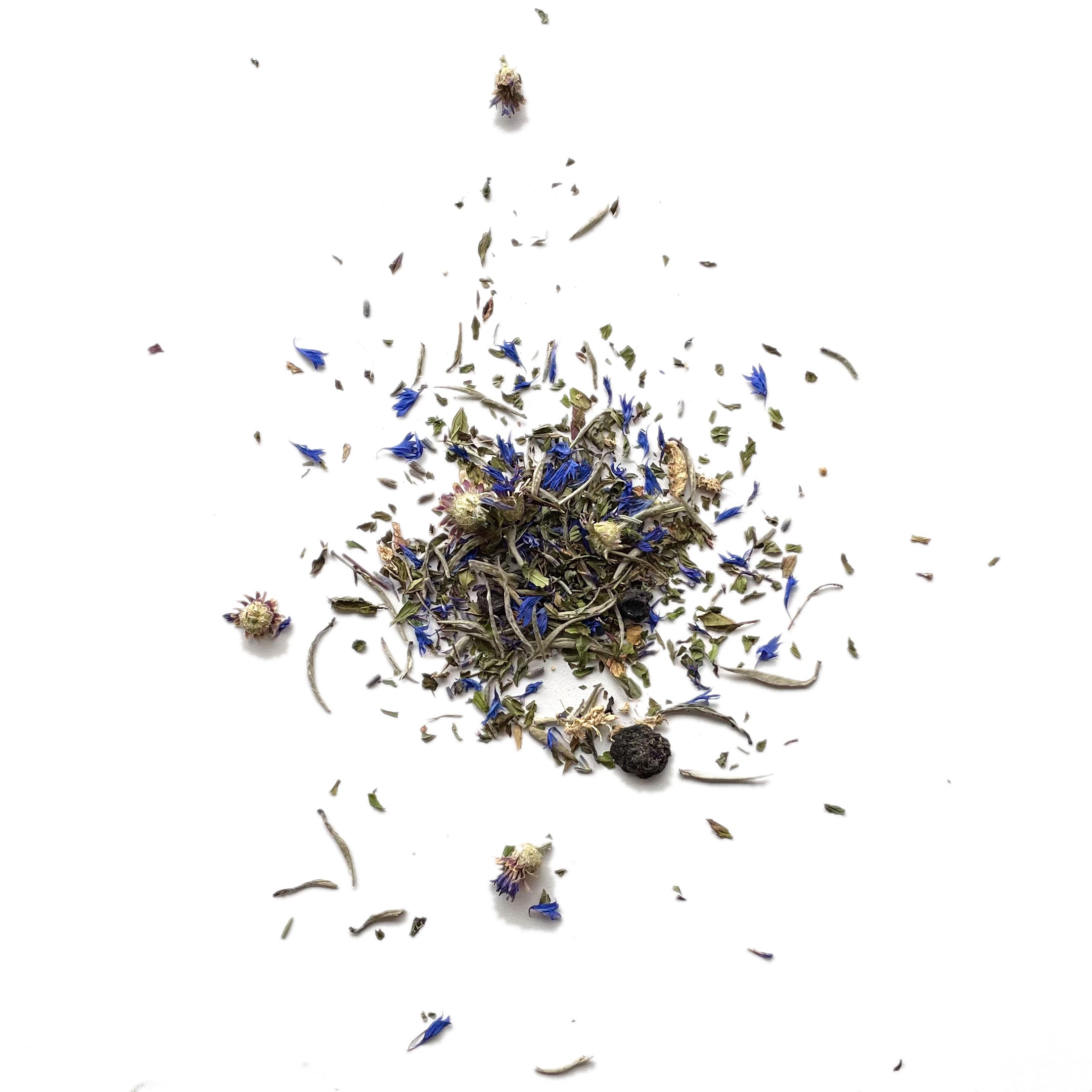 Heap of tea leaves scattered on a white background