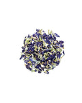 Bowl of dried butterfly pea flowers on a white background