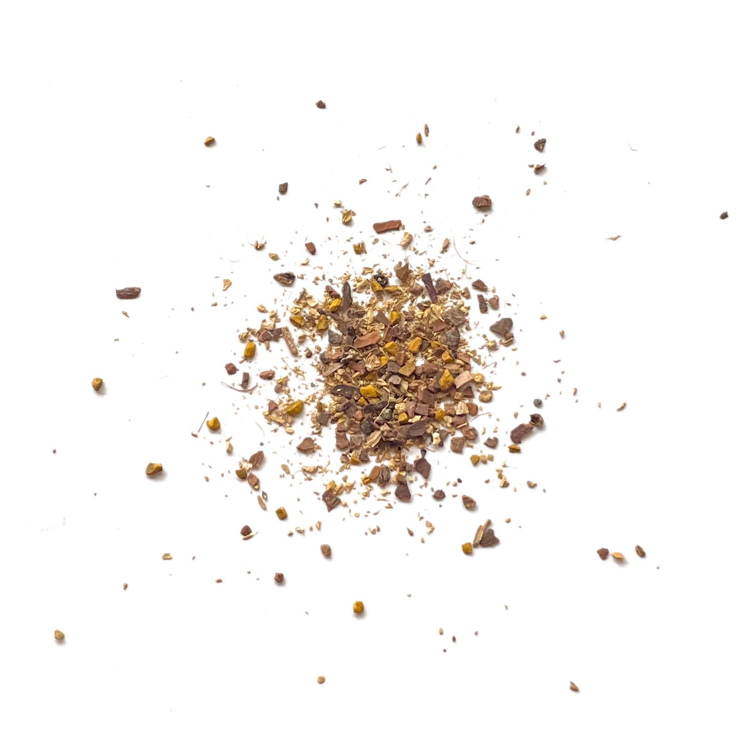 Dry herbal tea leaves scattered on a white background