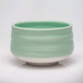 Green ceramic bowl on a white background