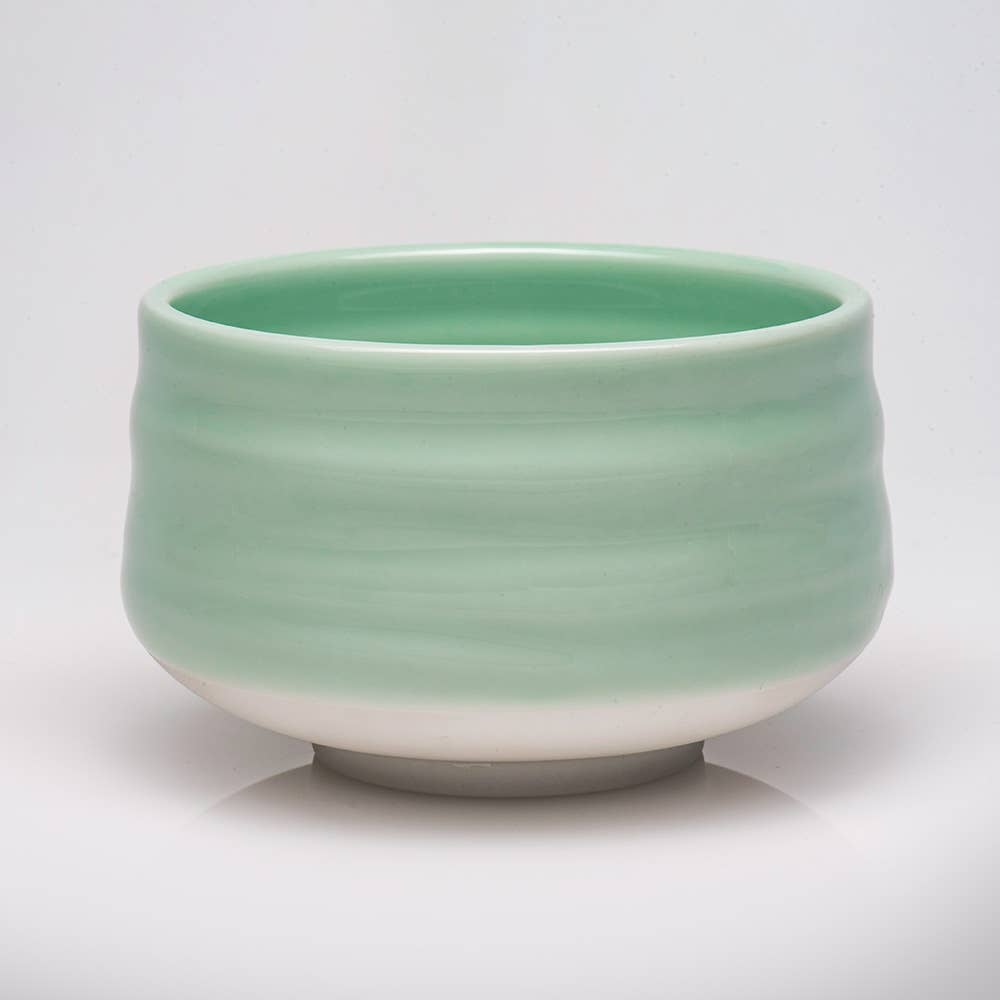 Green ceramic bowl on a white background