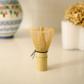 Bamboo whisk used for making matcha tea on a neutral background