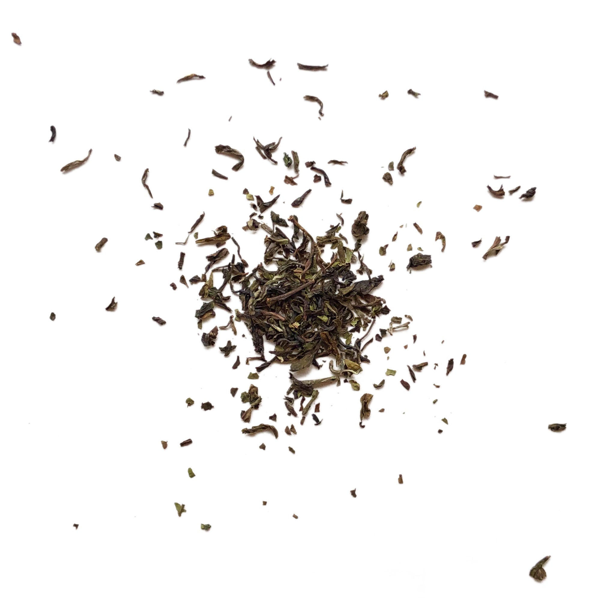 Dry tea leaves scattered on a white background