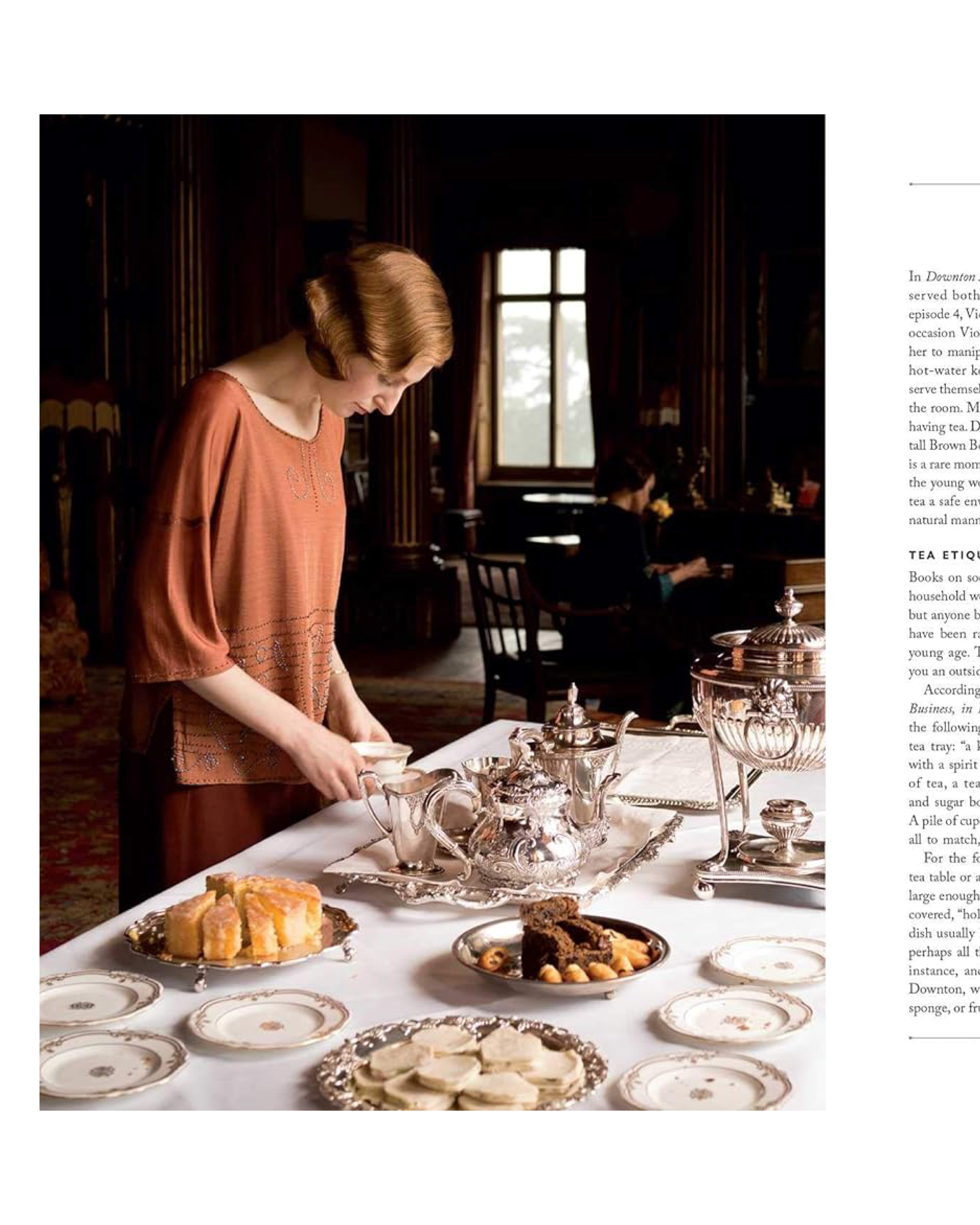 Woman setting a table with tea service and pastries in a vintage-style room.