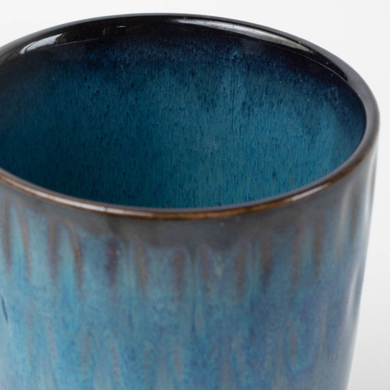 Close-up of a blue ceramic mug with a textured surface.