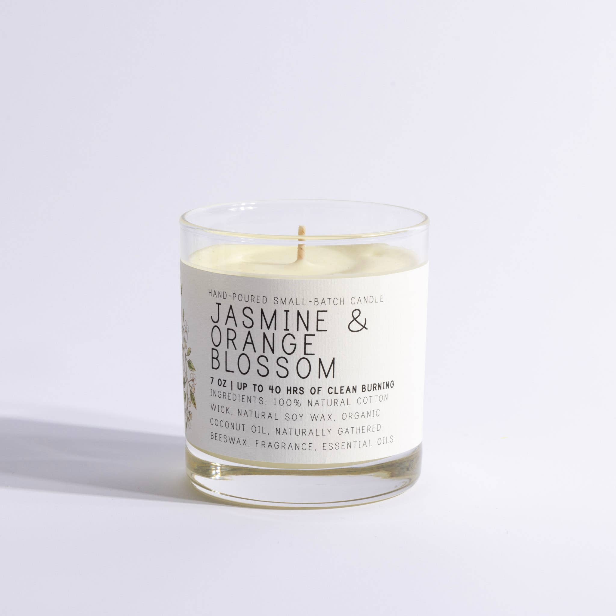 Candle with a label reading 'Jasmine & Orange Blossom' on a white background