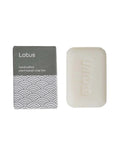 Handcrafted lotus soap bar with packaging on a white background