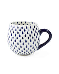 White mug with blue teardrop pattern on a white background