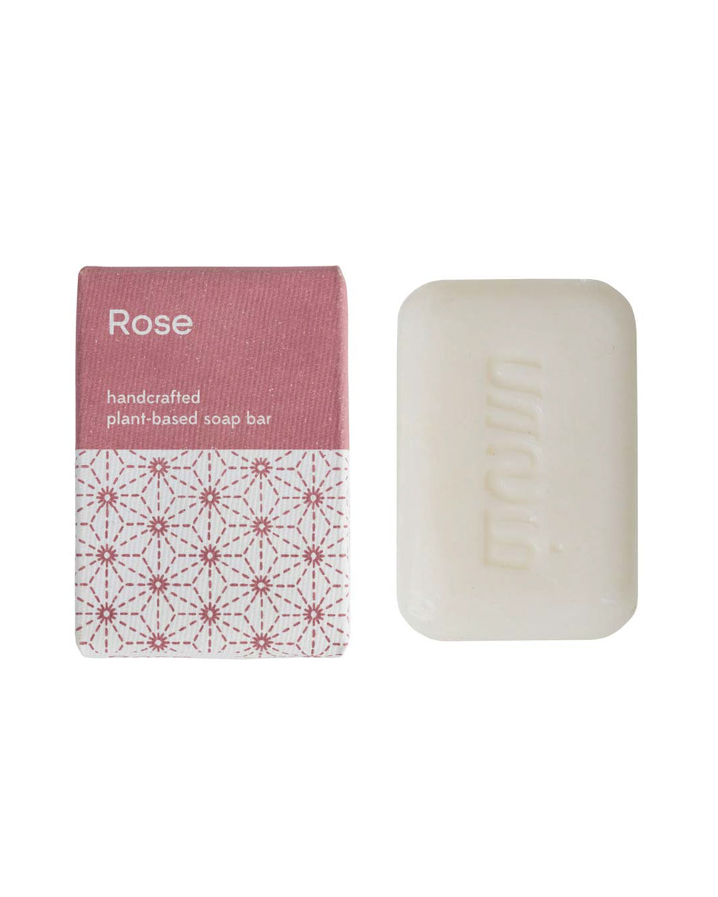 Handcrafted rose soap bar with packaging on a white background