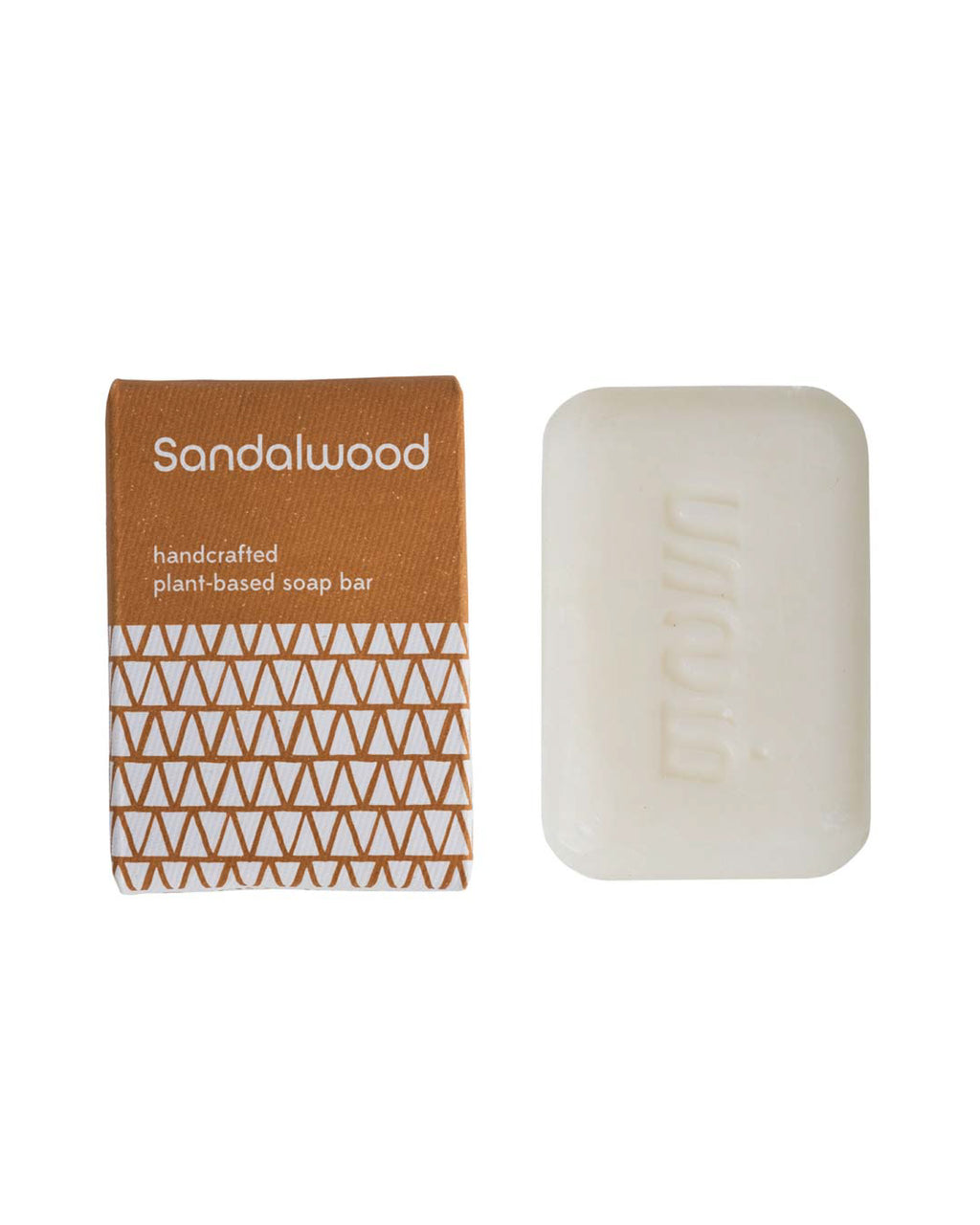 Handcrafted sandalwood soap bar with packaging on a white background