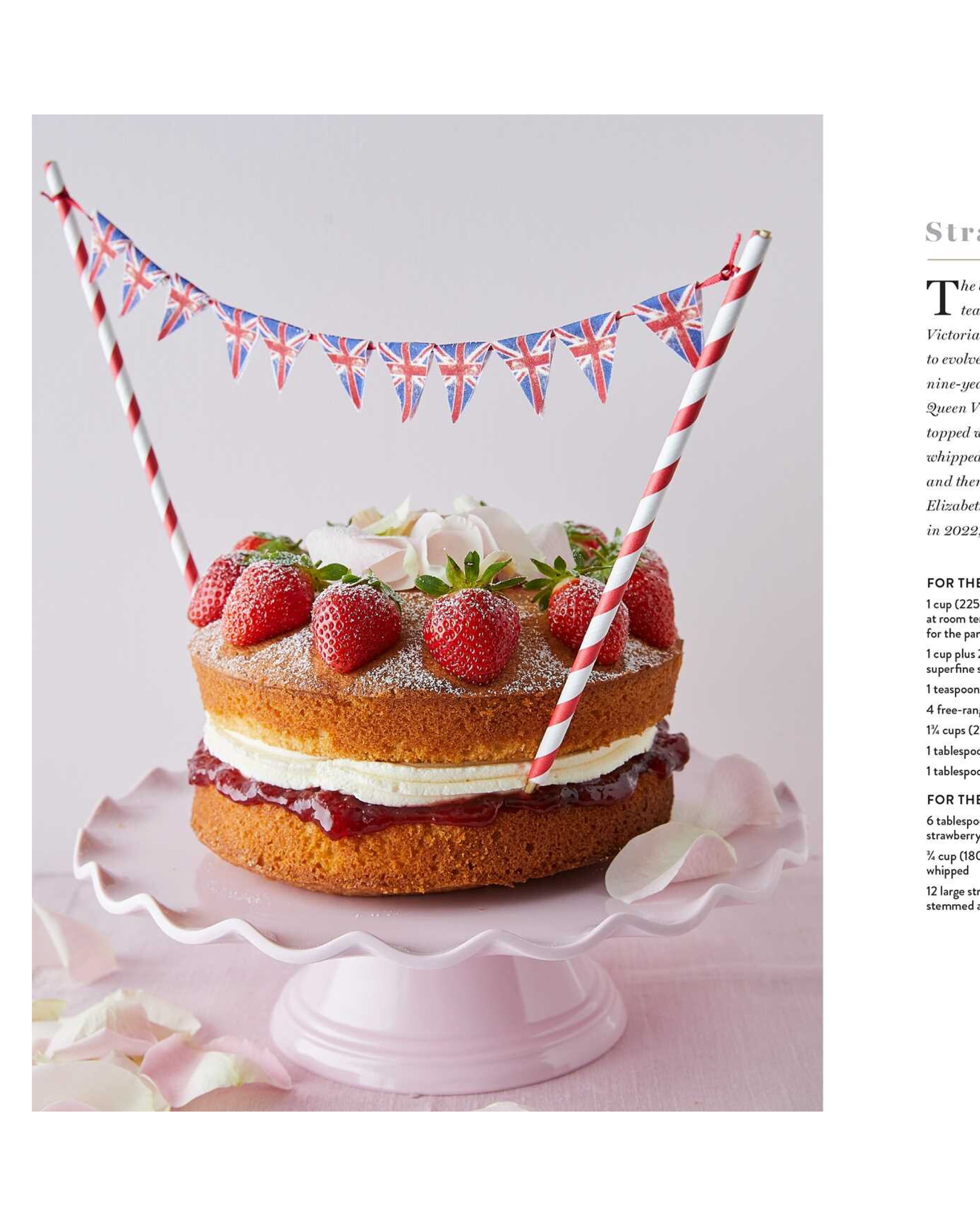 Layered cake with strawberries and British flag decoration on a white background