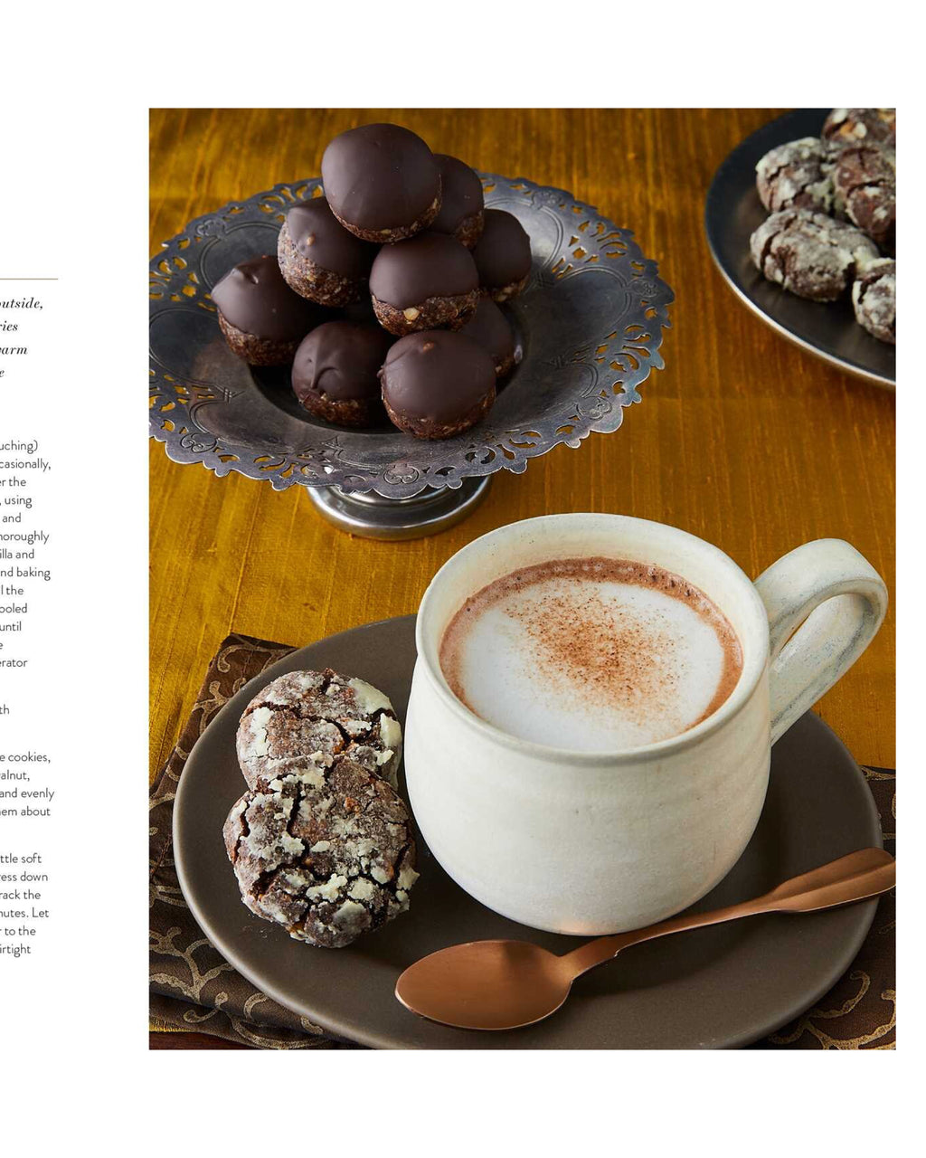 Cup of a hot drink with cookies and chocolate truffles on a wooden table