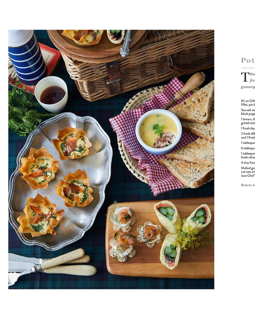 Assorted finger foods including canapés, soup, and bread on a table with a picnic basket.