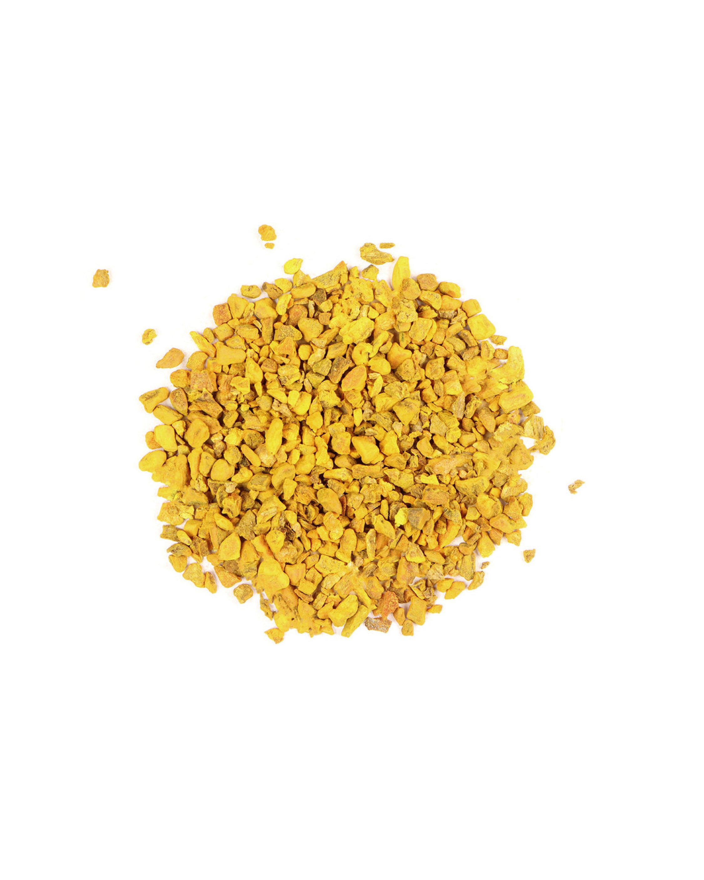 Pile of dried turmeric on a white background
